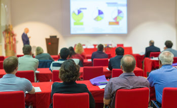 Audience in lecture hall on scientific conference.